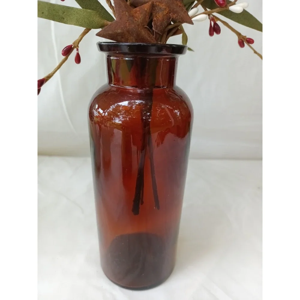 Amber apothecary bottle with red white pip berry pic w rusty stars